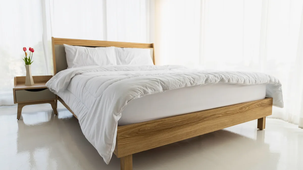 A made bed with white sheets in a bright, plain bedroom